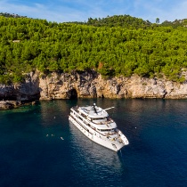 View of My Wish ship moored in Croatia next to a green island